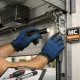 Técnico inspecciona puerta basculante de garaje en Madrid; ¿Que empresas de Madrid ofrecen mantenimiento para puertas de garaje basculantes?